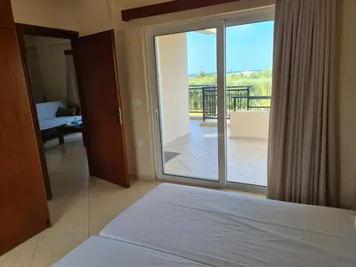 a bedroom with a bed and a view of a balcony at VILLA PAGONI Residence Selini Villas N 1 Kolymbari Chania in Kolymvari