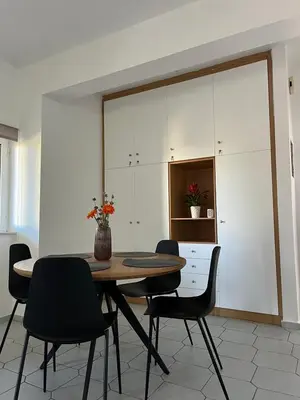 a dining room with a table and chairs at Anna's Apartment in Kato Daratso