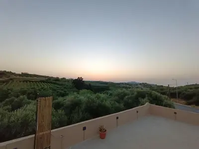 a view of the sunset from the balcony of a house at Vrachakia Stylish in Ayiá