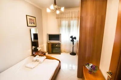 a small room with a bed and a television at Electra's House in Chania Town