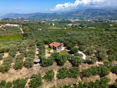an aerial view of a house on a hill with trees at Villa Fabrica Baladakis adults only in Metókhi