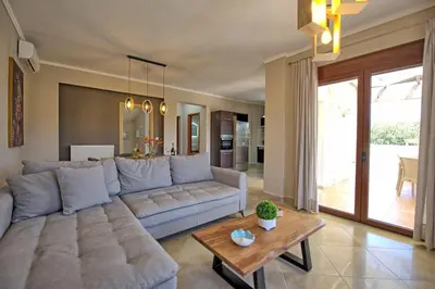 a living room with a couch and a table at Villa Kostantina by PosarelliVillas in Plaka