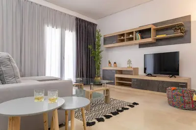a living room with a couch and a tv at Stefanos apartment Chania in Chania Town