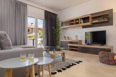 a living room with a couch and a tv at Stefanos apartment Chania in Chania Town