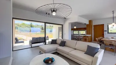 a living room with a couch and a table at Star Luxury Villa - Private pool, gym, playground in Kato Daratso