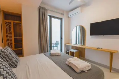 a bedroom with a bed with a flat screen tv at Star Luxury Villa - Private pool, gym, playground in Kato Daratso