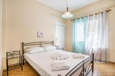 a bedroom with a bed with towels on it at Ortansia House near the Sea in Ayiá
