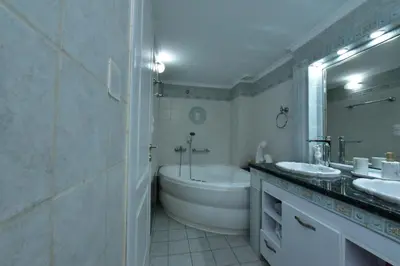 a bathroom with a tub and a sink and a bath tub at Zilina Homes2 in Chania Town