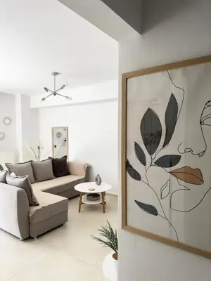 a living room with a couch and a table at Idene Penthouse in Chania Town