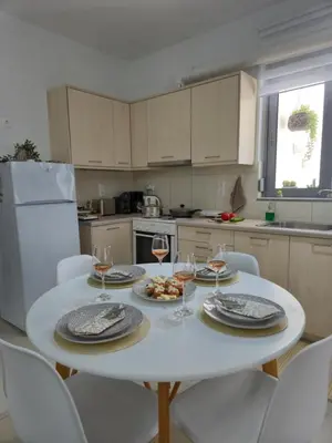 a kitchen with a white table with glasses of wine at Idene Penthouse in Chania Town