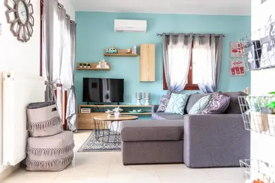 a living room with a couch and a tv at Vila Vasiliki, Next To Platanias, 6min From Sea in Vrísai