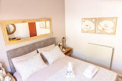 a bedroom with a bed with a mirror on the wall at Vila Vasiliki, Next To Platanias, 6min From Sea in Vrísai
