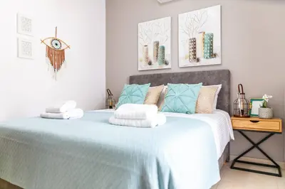 a bedroom with a blue and white bed with pillows at Vila Vasiliki, Next To Platanias, 6min From Sea in Vrísai