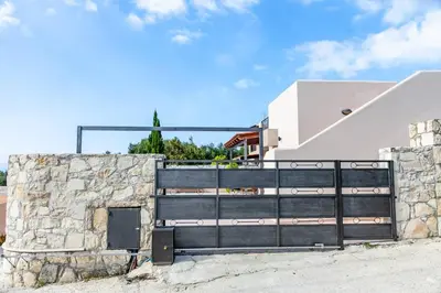 a gate to a house with a stone wall at Vila Vasiliki, Next To Platanias, 6min From Sea in Vrísai