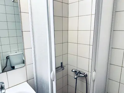 a bathroom with a shower and a sink at lifeguard beachfront - Luxury Flat, 30meters From Sea in Stalos