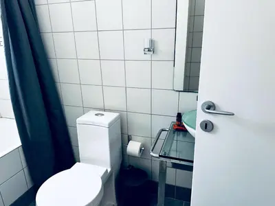 a small bathroom with a toilet and a mirror at lifeguard beachfront - Luxury Flat, 30meters From Sea in Stalos