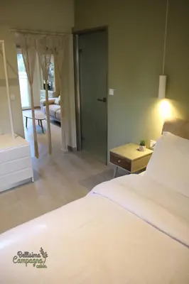 a bedroom with a bed and a living room at Bellisima Campagna Cabin Pelekapina - Chania Crete in Chania Town