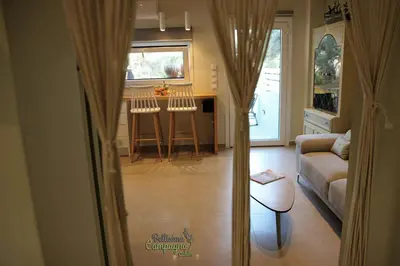 a living room with a couch and a table at Bellisima Campagna Cabin Pelekapina - Chania Crete in Chania Town