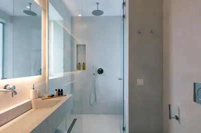 a bathroom with a shower with a glass door at Heniochos Villas in Chania Town