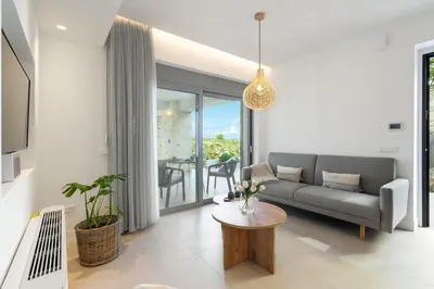 a living room with a couch and a table at Le Mont Blanc - with shared Pool in Kounoupidhianá