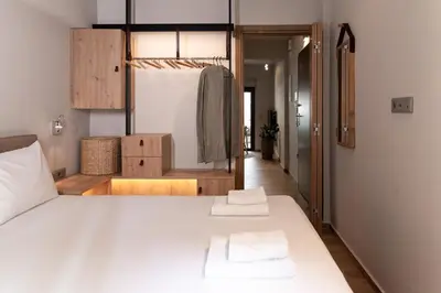 a bedroom with a bed with two towels on it at Anassa Seaside Residence- 50m from Sandy Beach in Chania Town