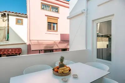 a bowl of fruit on a table on a balcony at On Luxury Chania in Chania Town
