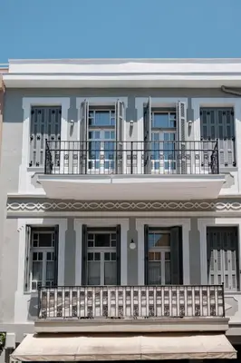 a large white building with a balcony at On Luxury Chania in Chania Town