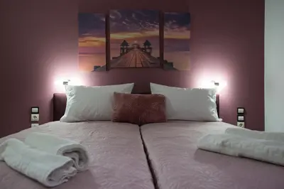 a bedroom with a large bed with towels on it at MARIHELEN APARTEMENTS in Kamisianá