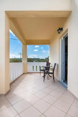 a patio with a table and chairs on a balcony at MARIHELEN APARTEMENTS in Kamisianá