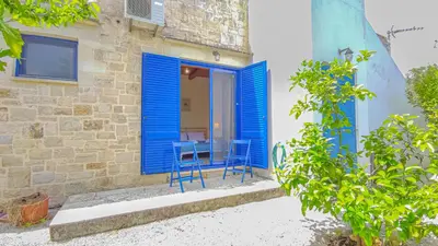 a house with blue doors and chairs in front of it at Lemon Tree Villa with Private Pool and Starlink Internet in Frés