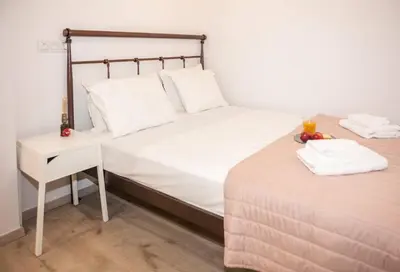 a bedroom with a bed and a side table at Secret Loft, 2min Walk From The Beach, High Tech in Chania Town