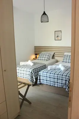 two beds in a room with two beds sidx sidx sidx sidx at Phaedra House For Relaxing Holidays Near Platanias in Vlakheronítissa