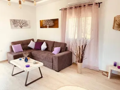 a living room with a couch and a table at Phaedra House For Relaxing Holidays Near Platanias in Vlakheronítissa