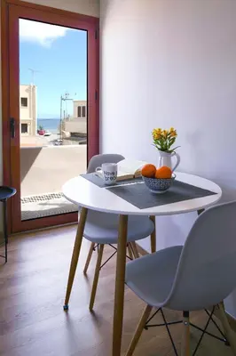 a table with chairs and a bowl of fruit on it at The Suite Spot - At The Heart Of The Old Town in Chania Town