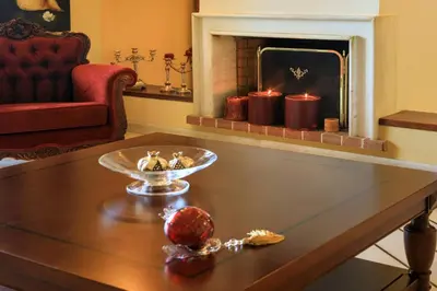 a living room with a fireplace and a table with candles at Koralia - Chanias Card Postal Villa Majestic View in Chania Town