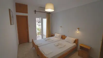a bedroom with a bed with towels on it at Ilingas Hotel in Khóra Sfakíon