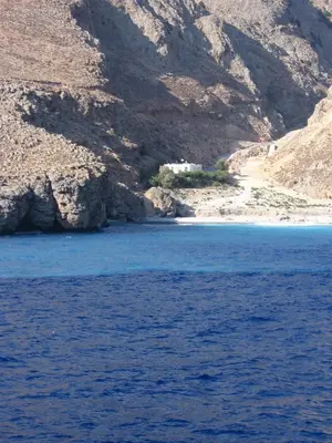 a large body of water next to a mountain at Ilingas Hotel in Khóra Sfakíon