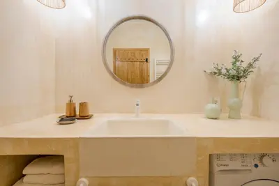 a bathroom with a sink and a mirror at Disegno Villa - Rooftop Pool in Kolymvari