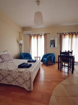 a bedroom with a bed and a table and chairs at Leli House in Chania Town
