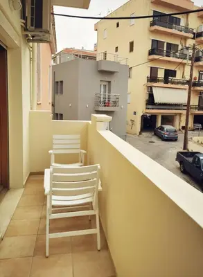two chairs sitting on the ledge of a balcony at Leli House in Chania Town