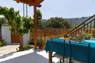 a blue table with fruits and vegetables on a patio at Eliva house in Chania Town