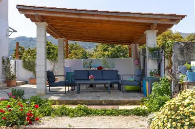 a pergola with a table and chairs on a patio at Eliva house in Chania Town