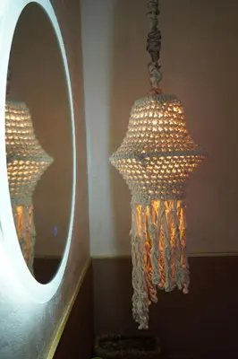 a chandelier in front of a mirror in a room at L A Boutique Suites with Private Hot Tub in Kalathas