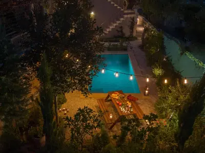 an overhead view of a swimming pool at night at Rimondi Residences Chania in Chania Town