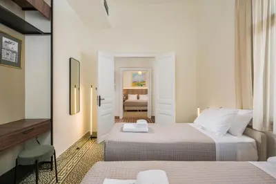 a hotel room with two beds and a bedroom at Tatianas Kanevaro in Chania Town