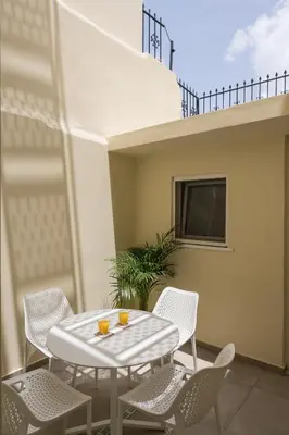 a patio with a table and chairs on a balcony at Tatianas Kanevaro in Chania Town