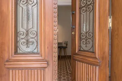 a pair of wooden doors next to each other at Tatianas Kanevaro in Chania Town