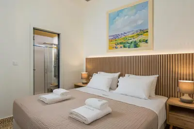 a bedroom with two white towels on a bed at Tatianas Kanevaro in Chania Town