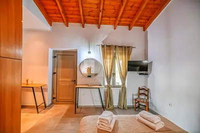 a living room with a table and a chair at Haroto Home Residence in Plokamianá