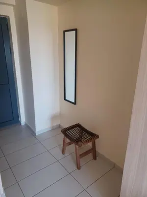 a bench sitting in a room with a mirror at City Spot Chania in Chania Town